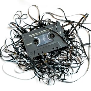 a pile of black and white wires and a cassette