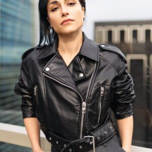 A woman in a black leather jacket posing for a picture